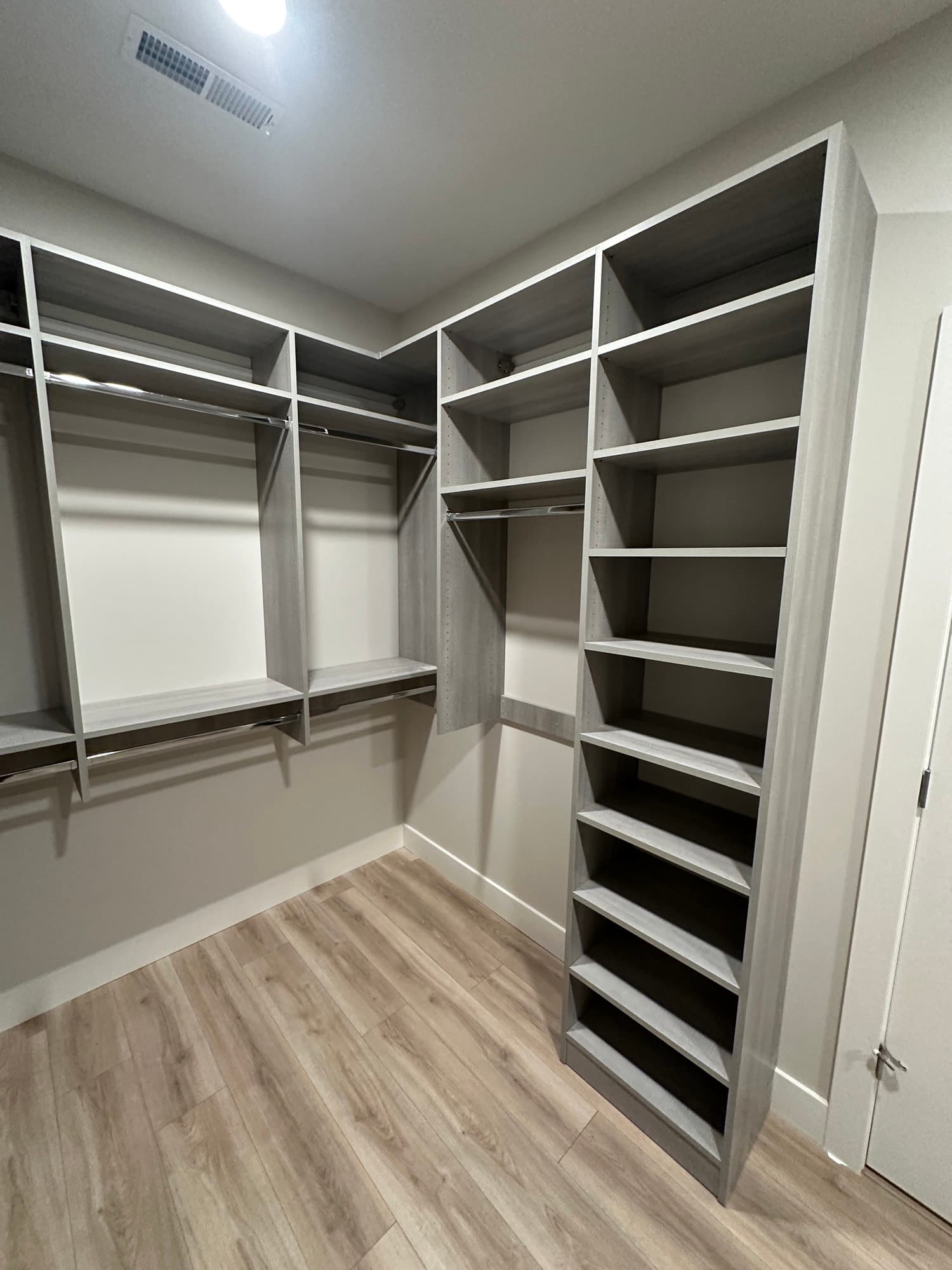 Walk-in closet with oak finish and drawer bank