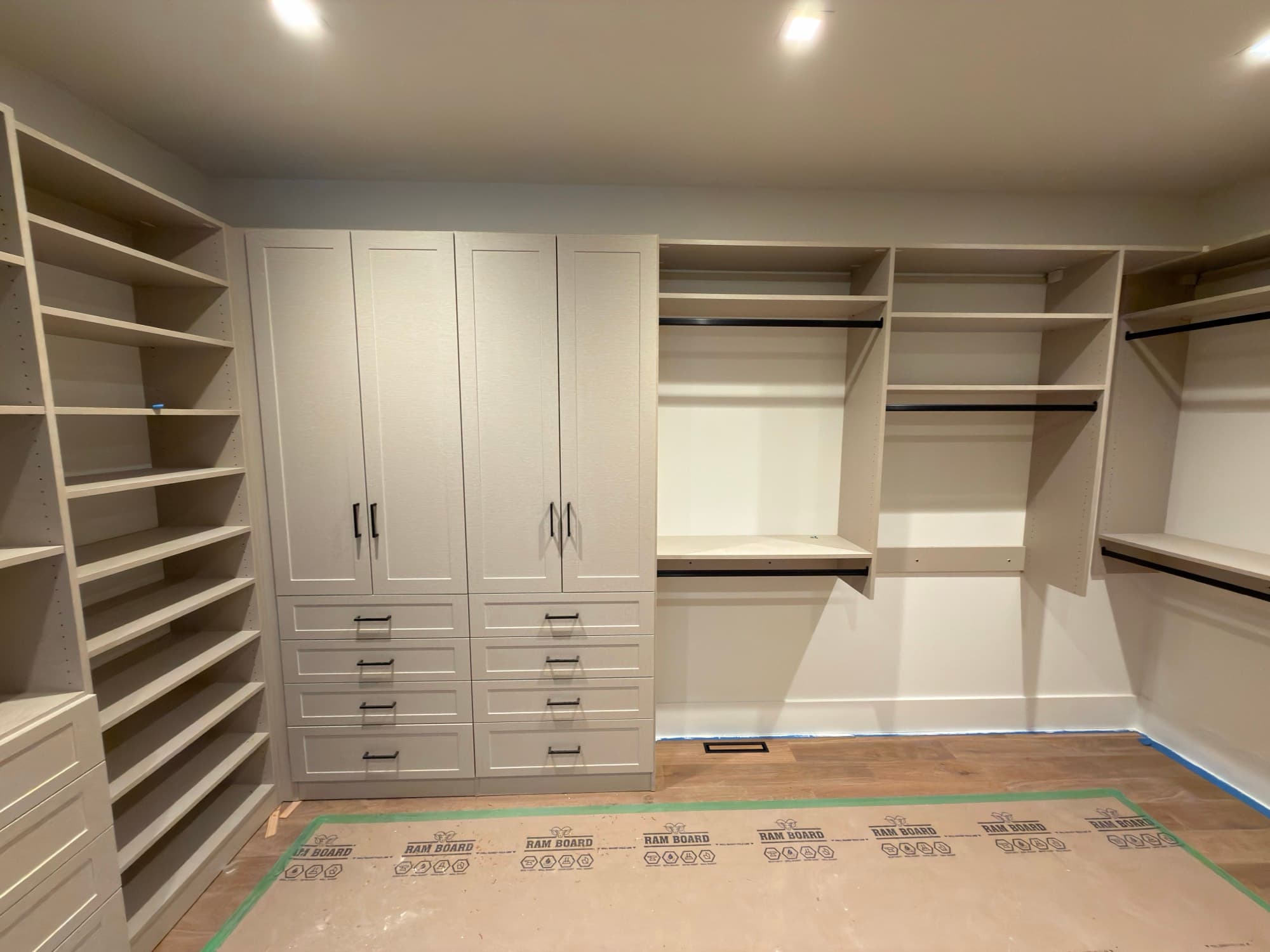 Walk-in closet with walnut island and marble top