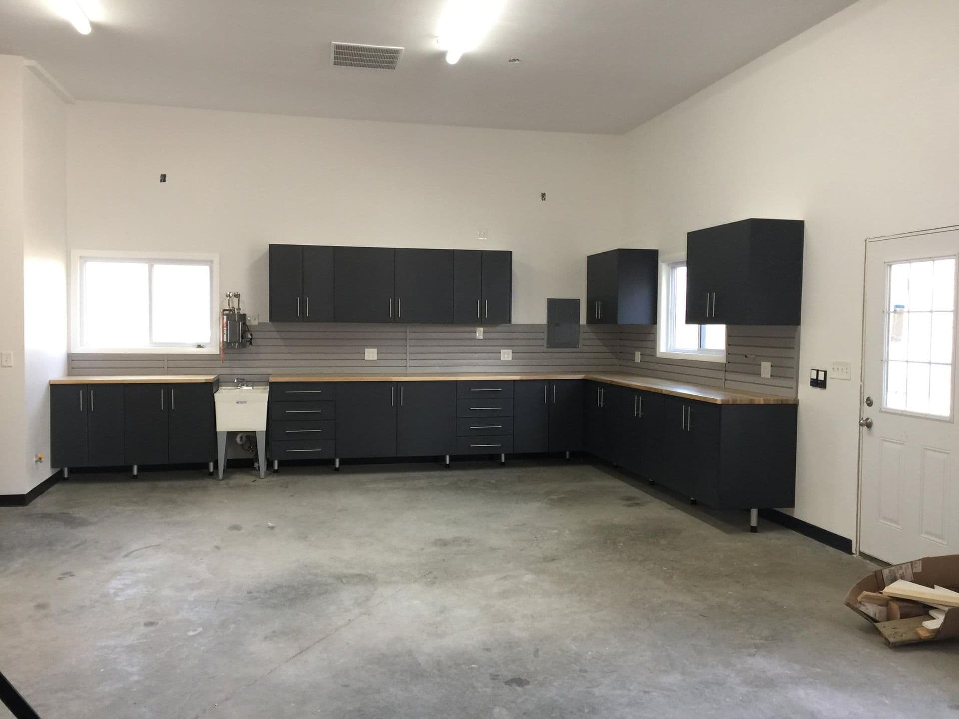 Garage with black cabinets and clean workshop floor in Columbia, MO