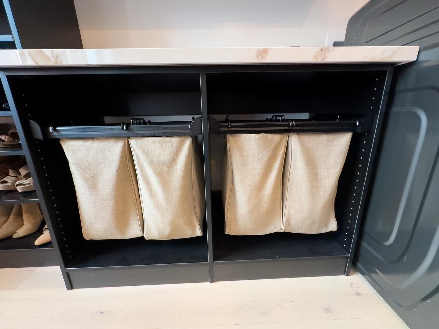 Laundry room with cabinets and slide-out hampers